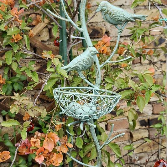 An exquisite faux tree-shaped garden stake with a beautifully crafted simulated bird's nest, perfect for farmhouse gardens and villa courtyard landscaping decor