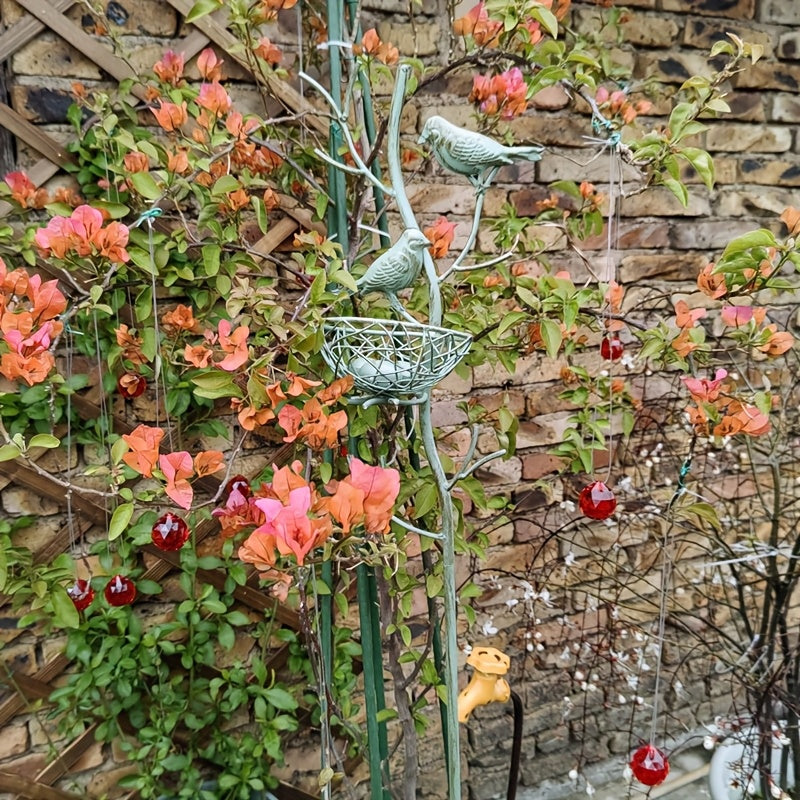 An exquisite faux tree-shaped garden stake with a beautifully crafted simulated bird's nest, perfect for farmhouse gardens and villa courtyard landscaping decor